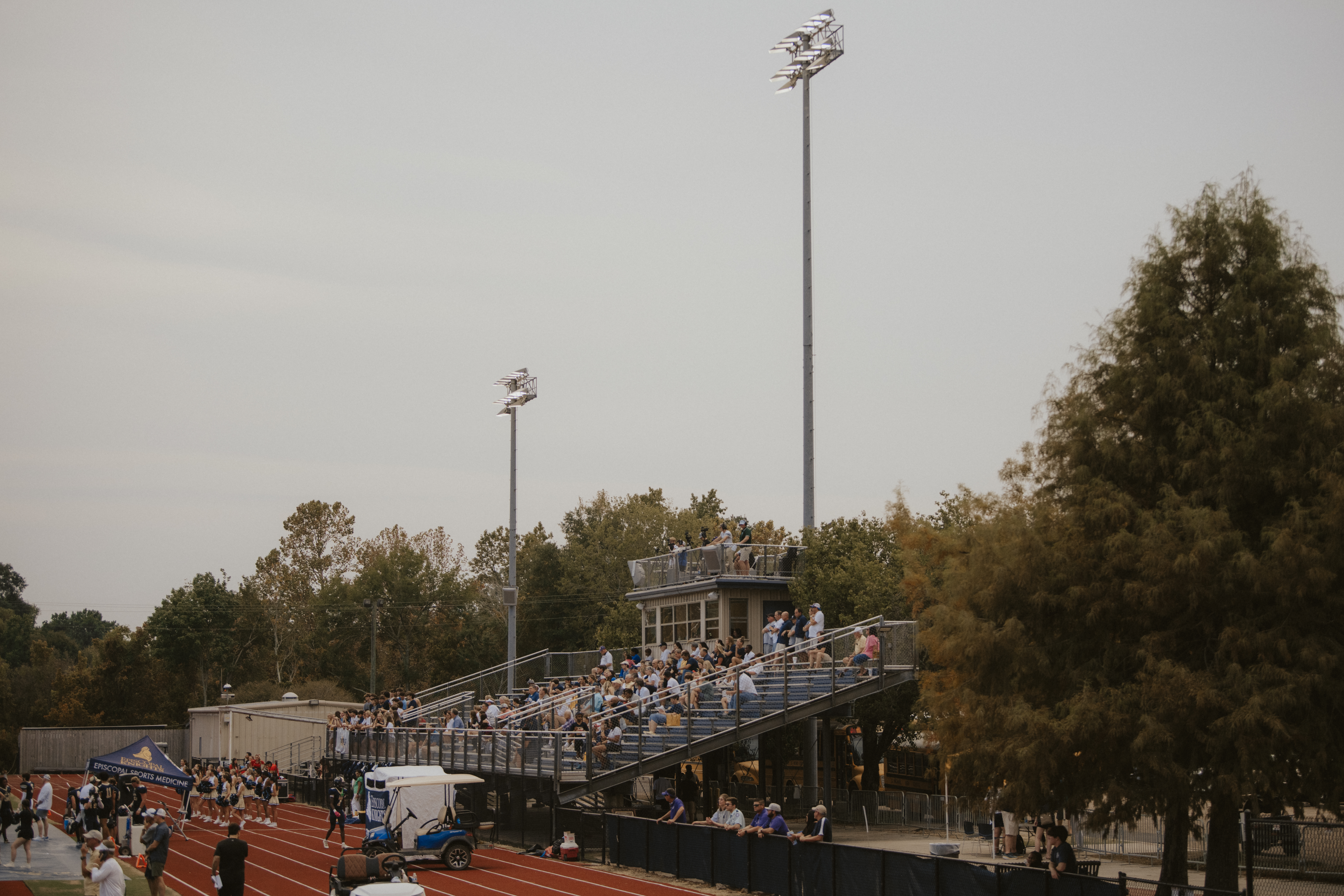 View across the Episcopal stadium showing the stands, track, and field the system was designed to cover.