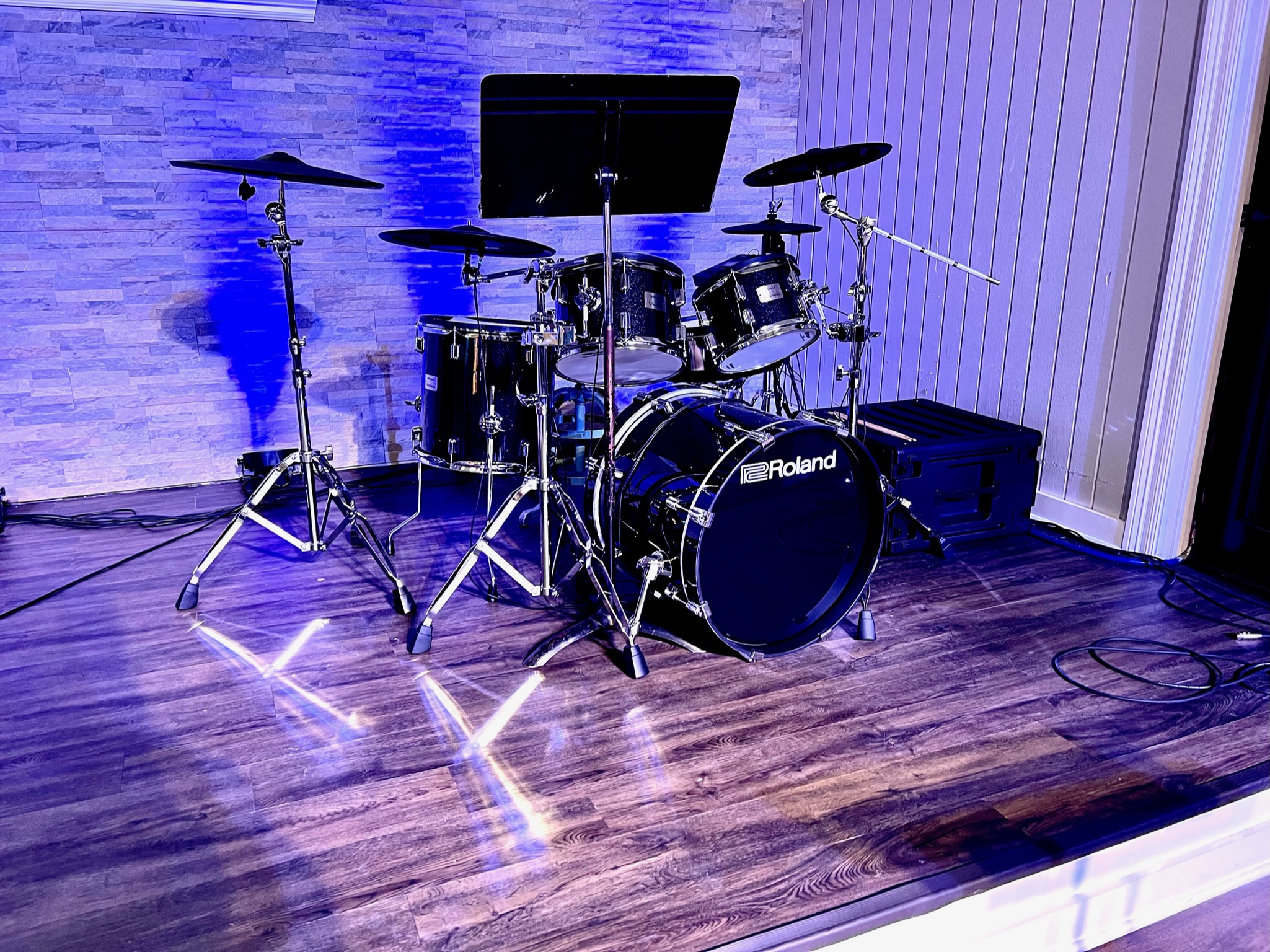 Galilee Baptist platform under Elation lighting — programmed wash on the worship band setup.