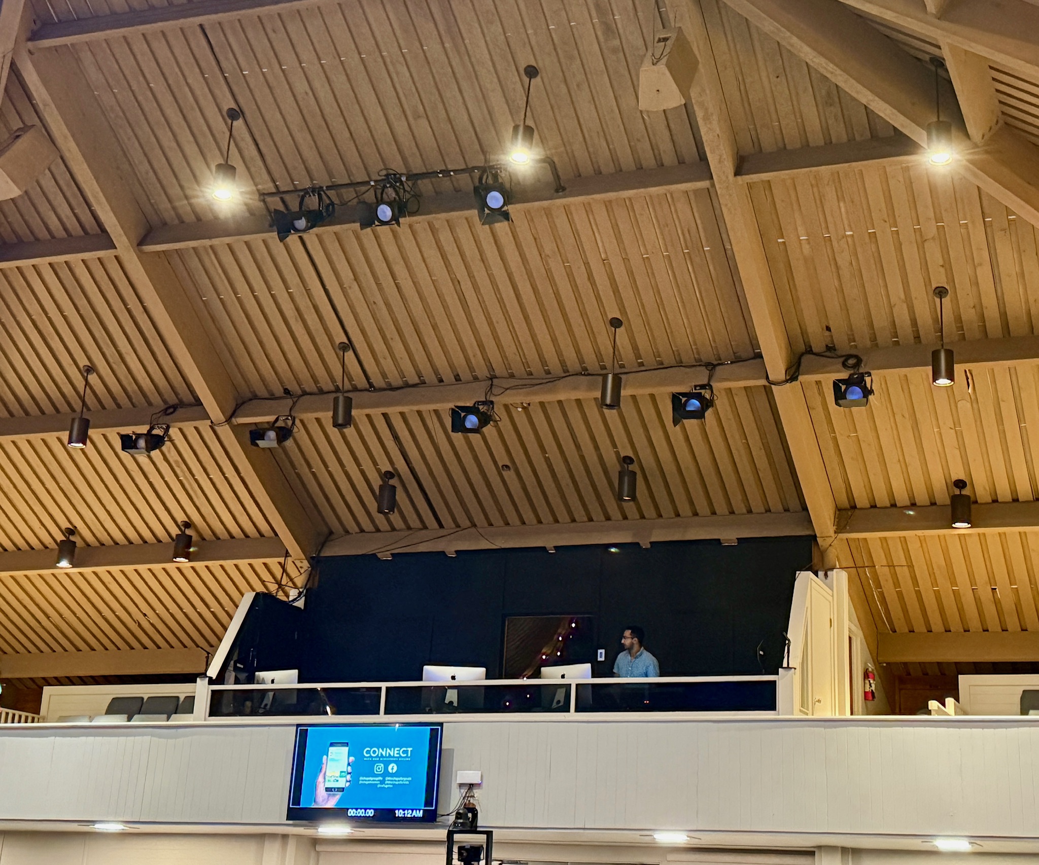Install day at The Chapel — wider view showing the lift positioned for fixture mounting and gear staged on the floor.