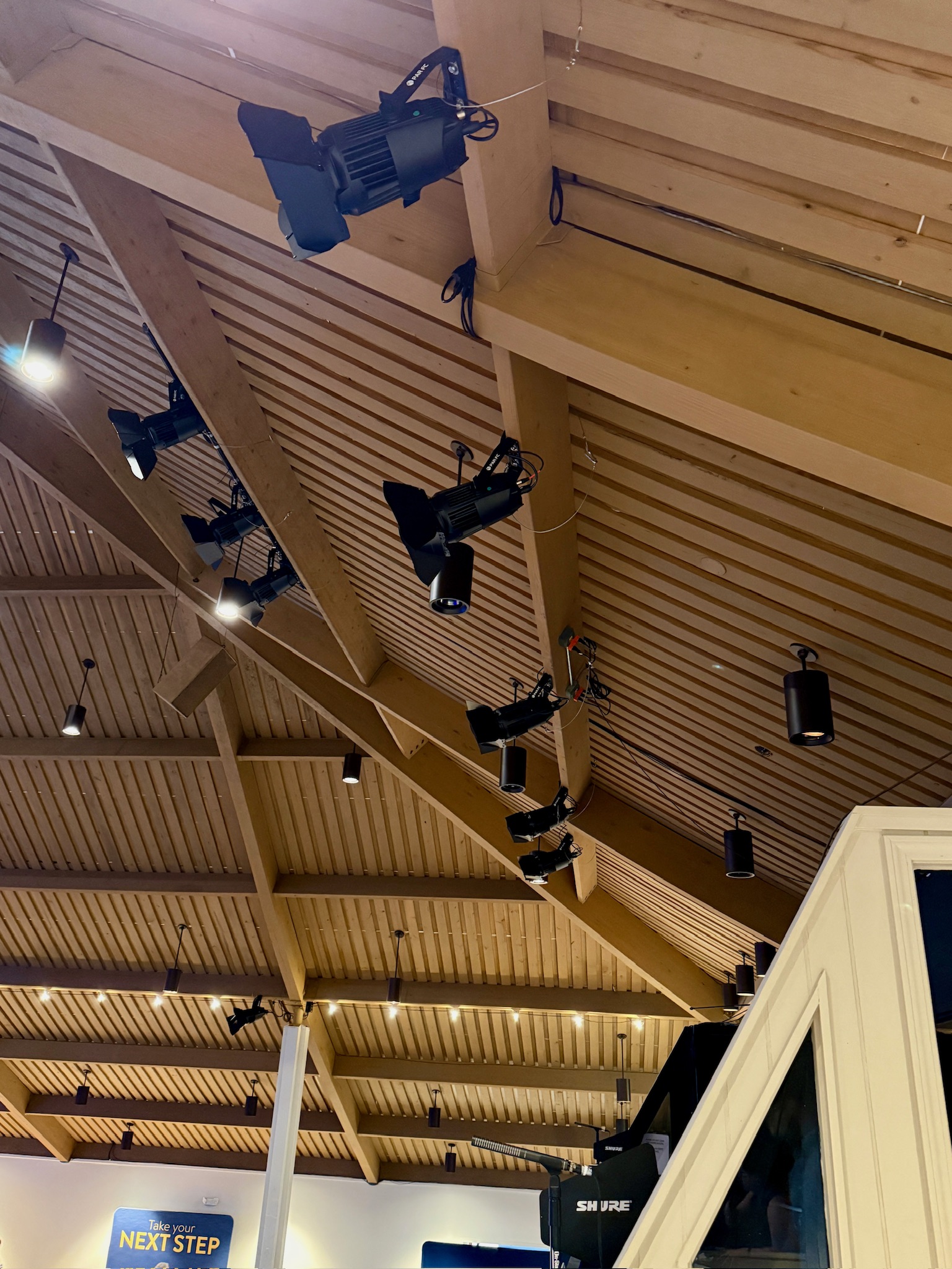 The Chapel on the Campus sanctuary — exposed-wood ceiling with Elation KL Par FC fixtures hard-mounted into the wood overhead.